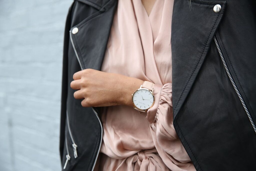 Stylish woman in a leather jacket showcasing an elegant wristwatch, perfect for fashion-forward individuals.